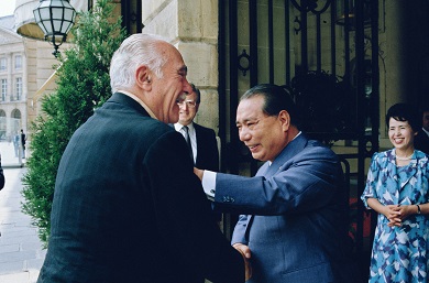 Two men greeting each other, delighted to meet again.