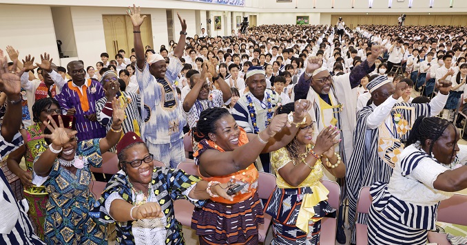 People cheering in a hall.