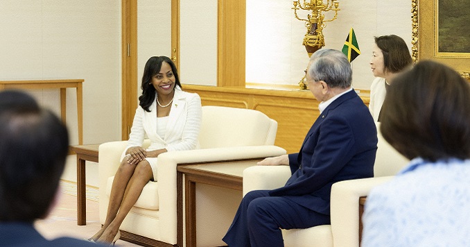 Several people gathered in a spacious meeting room for a discussion.