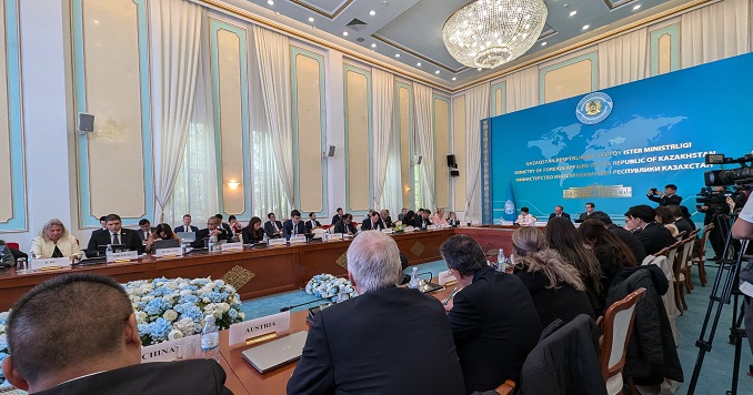 Dozens of leaders from various countries in discussion at a round table.