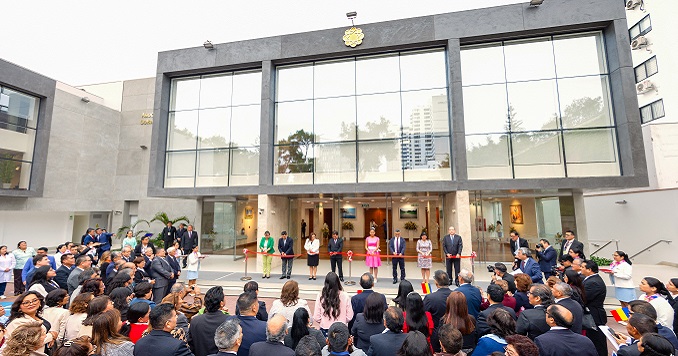 People are gathered watching the ribbon cutting at an opening ceremony of a new center.