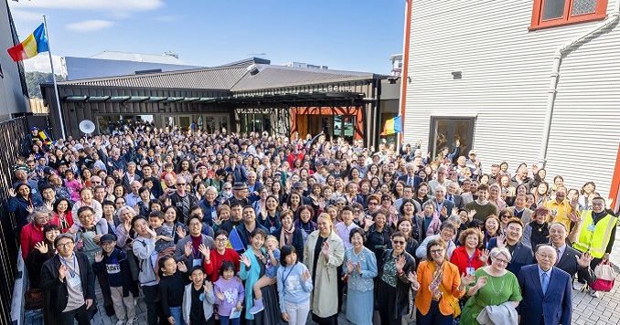 A large group of people standing in front of a building