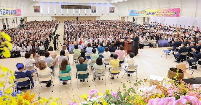 Large auditorium filled with people.