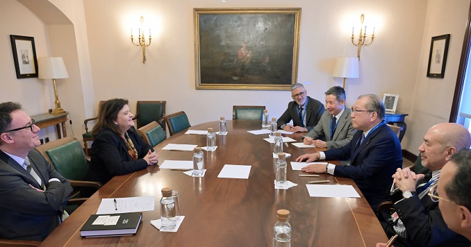 People sitting across from each other at a conference table.