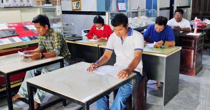 People taking an exam in a classroom.