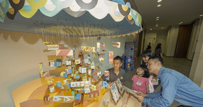 Children viewing a colorful, interactive display.